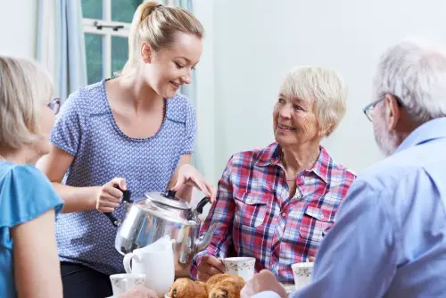 Volunteer Helping At Social Club For Seniors