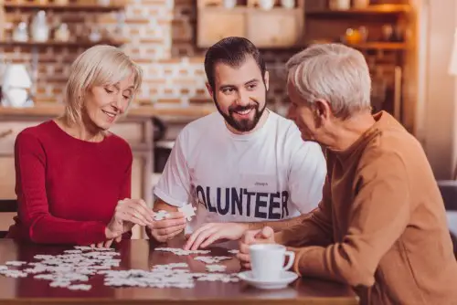 Volunteer playing games in senior living community